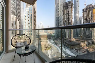 a balcony with a glass table and a view of a city at The Lofts West, Downtown Dubai - Mint Stay in Dubai