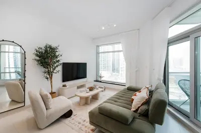 a living room with a couch and chairs and a tv at The Lofts West, Downtown Dubai - Mint Stay in Dubai