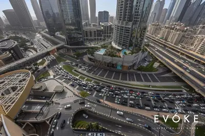a traffic jam in a city with tall buildings at Kempinski Luxe Studio Burj Khalifa View by Evoke in Dubai