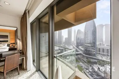 a hotel room with a view of a city at Kempinski Luxe Studio Burj Khalifa View by Evoke in Dubai