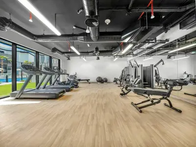 a gym with treadmills and cardio machines at Luxury Apartment In JVC With Padel Gym Pool Cinema BBQ in Dubai