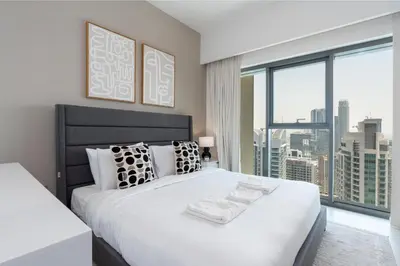 a bedroom with a large white bed with a large window at Burj Royale Luxury Burj Khalifa dubai mall downtown city centre in Dubai