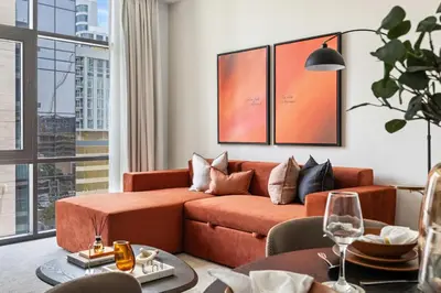 a living room with a couch and a table at Stylish 1BR with Work Desk, Pool and Gym in Dubai