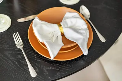 an orange plate with a yellow bow tie on it at Stylish 1BR with Work Desk, Pool and Gym in Dubai