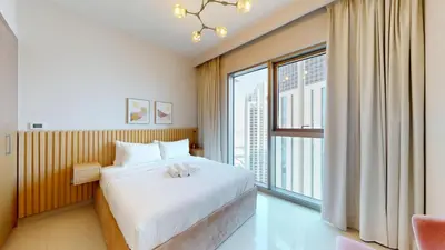 a bedroom with a bed and a large window at Harbour Views - Chic Three Bed with Creek Views in Dubai