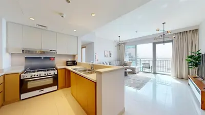 a kitchen with a sink and a stove at Harbour Views - Chic Three Bed with Creek Views in Dubai