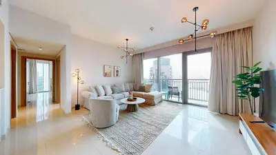a living room with a couch and a table at Harbour Views - Chic Three Bed with Creek Views in Dubai