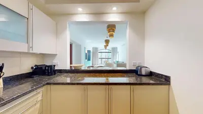 a kitchen with white cabinets and a counter top at Golden Mile - Serene Two Bedroom on the Palm in Dubai