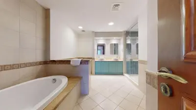 a large bathroom with a tub and a sink at Golden Mile - Serene Two Bedroom on the Palm in Dubai