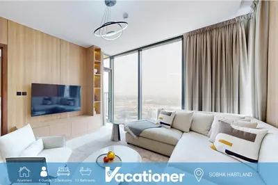 a living room with a couch and a tv at The Crest A - Premium Two Bedroom High-Rise Escape in Dubai
