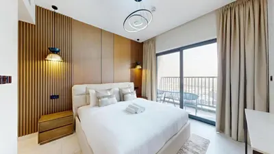 a bedroom with a large white bed and a balcony at The Crest A - Premium Two Bedroom High-Rise Escape in Dubai