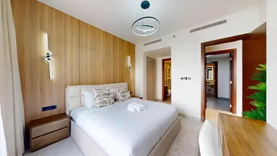 a bedroom with a white bed and a wooden wall at The Crest A - Premium Two Bedroom High-Rise Escape in Dubai