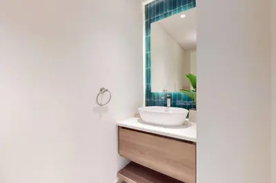 a bathroom with a sink and a mirror at Al Dabas - One Bed with Beach Access and Sea View in Dubai