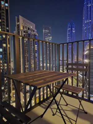 a wooden bench on a balcony with a city skyline at Creek crescent high floor in Dubai