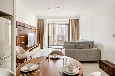a living room with a table and a couch at Creek crescent high floor in Dubai
