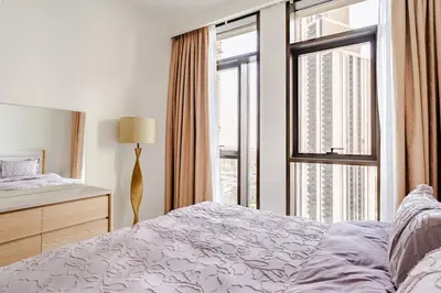 a bedroom with a bed and a large window at Creek crescent high floor in Dubai