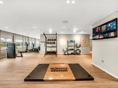 a gym with a treadmill and a gymnasium at Cozy Luxury One Bedroom Sea View on Private Beach and Infinity Pool in Dubai