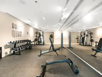 a gym with dumbbells and a lot of equipment at Cozy Luxury One Bedroom Sea View on Private Beach and Infinity Pool in Dubai