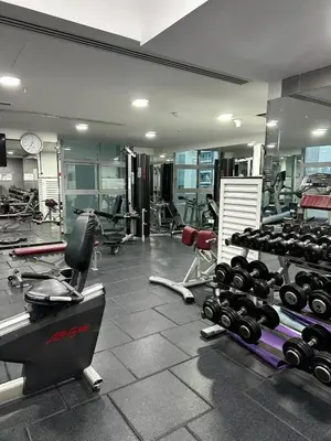 a gym with a lot of equipment in a room at Lux 3 BR Sea View Condo with Pool & Sauna In Marina in Dubai
