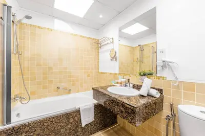 a bathroom with a sink and a tub and a toilet at Jbr shams apartment in Dubai