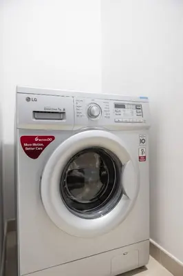a white washing machine sitting in a room at Jbr shams apartment in Dubai