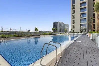 a large swimming pool in the middle of a building at Studio in Azizi with Pool and Gym Access in Dubai