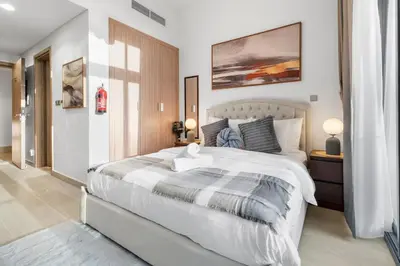 a bedroom with a large white bed in a room at Studio in Azizi with Pool and Gym Access in Dubai