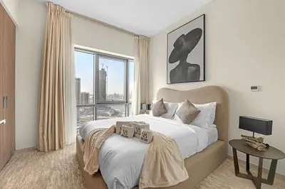 a bedroom with a large bed and a large window at Guest Favorite - Premium & Modern 2BR Stay at Dubai Creek Harbour in Dubai