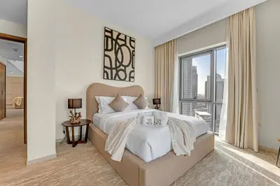 a bedroom with a large bed and a large window at Guest Favorite - Premium & Modern 2BR Stay at Dubai Creek Harbour in Dubai