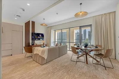 a living room with a table and a couch at Guest Favorite - Premium & Modern 2BR Stay at Dubai Creek Harbour in Dubai