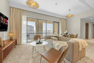 a living room with a couch and a table at Guest Favorite - Premium & Modern 2BR Stay at Dubai Creek Harbour in Dubai