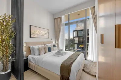 a bedroom with a large bed and a large window at Chic Urban Studio in Dubai in Dubai