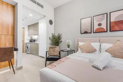 a bedroom with a bed and a kitchen at Fully Furnished Studio with Scenic Views in Dubai