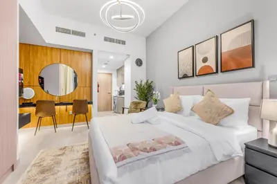 a bedroom with a white bed and a dining room at Fully Furnished Studio with Scenic Views in Dubai