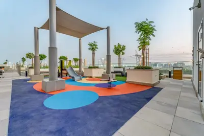 a lobby with tables and chairs in a building at Fully Furnished Studio with Scenic Views in Dubai