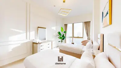 a white room with two beds and a couch at Next to Burj Khalifa & Dubai Mall Grande Signature 2BR , Enjoy Dubai Skyline from Balcony Like Home in Dubai