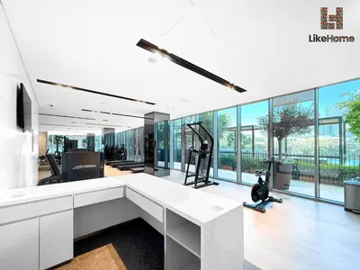 an office with a white desk and large windows at Next to Burj Khalifa & Dubai Mall Grande Signature 2BR , Enjoy Dubai Skyline from Balcony Like Home in Dubai