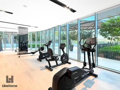a gym with treadmills and ellipticals in a building at Next to Burj Khalifa & Dubai Mall Grande Signature 2BR , Enjoy Dubai Skyline from Balcony Like Home in Dubai