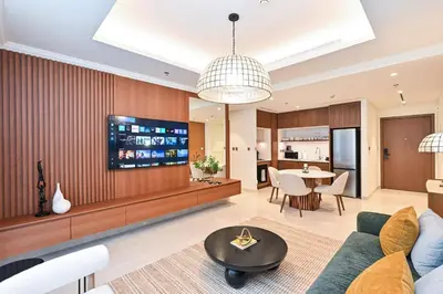a living room with a couch and a tv at Beach Serenity, Modern 1BR in Dubai, Palace Beach Residences, Emaar Beachfront in Dubai