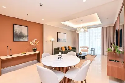 a living room with a table and chairs at Beach Serenity, Modern 1BR in Dubai, Palace Beach Residences, Emaar Beachfront in Dubai