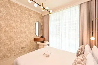 a bedroom with a white bed and a window at Beach Serenity, Modern 1BR in Dubai, Palace Beach Residences, Emaar Beachfront in Dubai