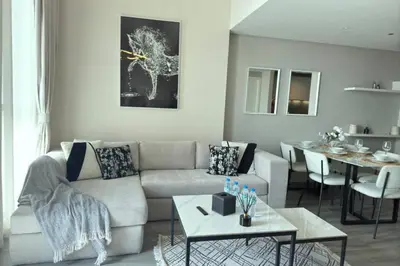 a living room with a couch and a table at Amazing 2BR Peaceful Views in Midtown Near Sports City in Dubai