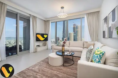 a living room with a white couch and large windows at Vogue Downtown Forte near Dubai Mall and Burj Khalifa, Two-Bedroom Apartment with Balcony and City View, full access to all amenities in Dubai