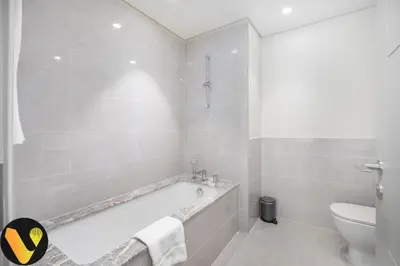 a bathroom with a bath tub and a toilet at Vogue Downtown Forte near Dubai Mall and Burj Khalifa, Two-Bedroom Apartment with Balcony and City View, full access to all amenities in Dubai