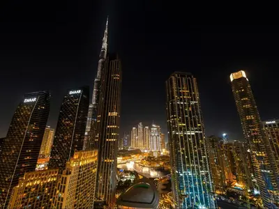 a night view of a city with tall buildings at Vogue Downtown Forte near Dubai Mall and Burj Khalifa, Two-Bedroom Apartment with Balcony and City View, full access to all amenities in Dubai