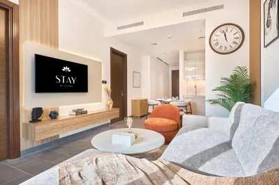 a living room with a couch and a tv at STAY BY LATINEM Luxury 1BR and Study Holiday Home CC 2808 Near Downtown in Dubai