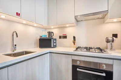 a kitchen with a sink and a stove at STAY BY LATINEM Luxury 1BR and Study Holiday Home CC 2808 Near Downtown in Dubai