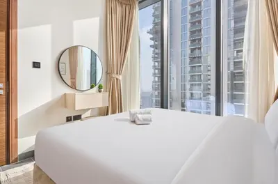a bedroom with a large white bed and a large window at STAY BY LATINEM Luxury 1BR and Study Holiday Home CC 2808 Near Downtown in Dubai