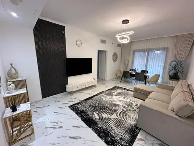 a living room with a couch and a flat screen tv at Marina Bliss-Live where Luxury Meets the Sea in Dubai