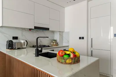 a basket of fruit on a counter in a kitchen at VayK - Brand New and Bright 1BR in JVC in Dubai